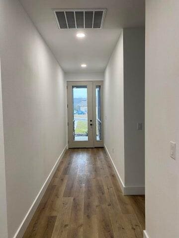 doorway with hardwood / wood-style floors