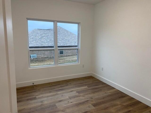 spare room with hardwood / wood-style flooring