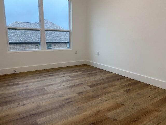 spare room with wood-type flooring