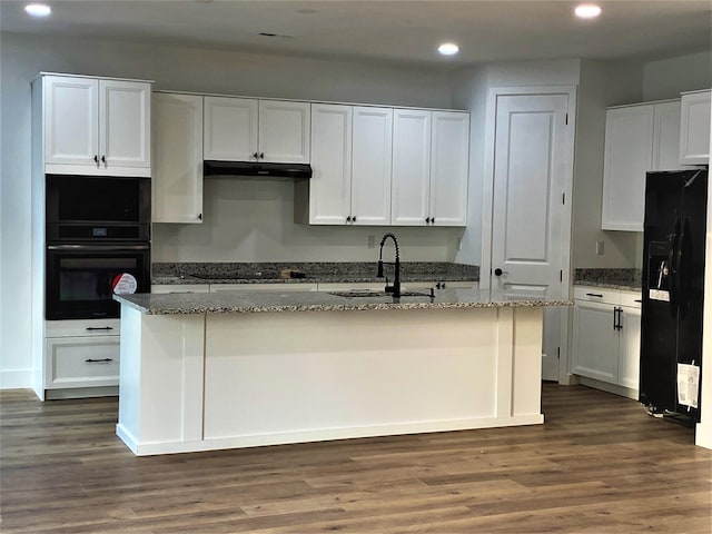 kitchen with white cabinetry, sink, black appliances, and a center island with sink