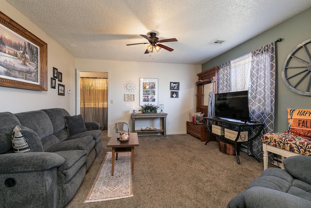 living room with carpet flooring, ceiling fan, and a textured ceiling