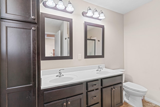 bathroom featuring tile patterned flooring, vanity, and toilet