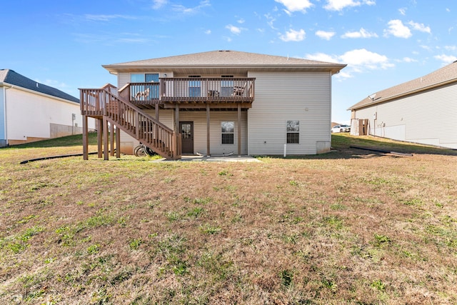 rear view of house with a yard and a deck