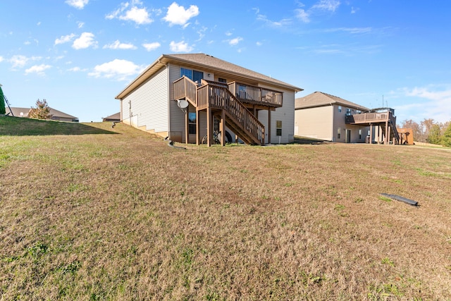 back of house with a lawn and a deck