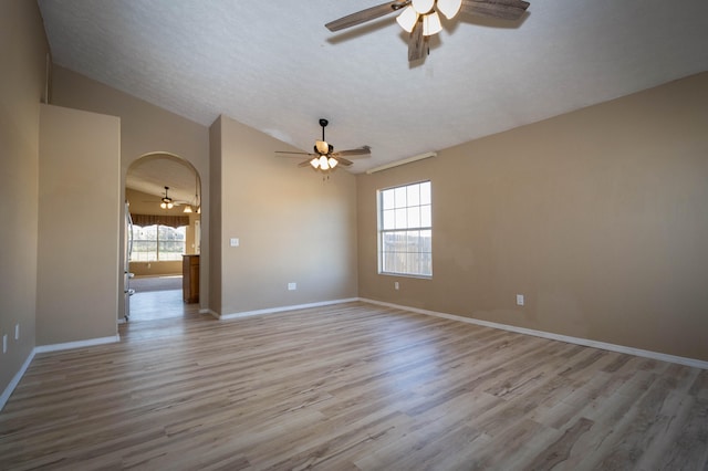 spare room with ceiling fan, light hardwood / wood-style floors, and lofted ceiling