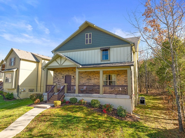 view of front of property featuring covered porch and a front yard