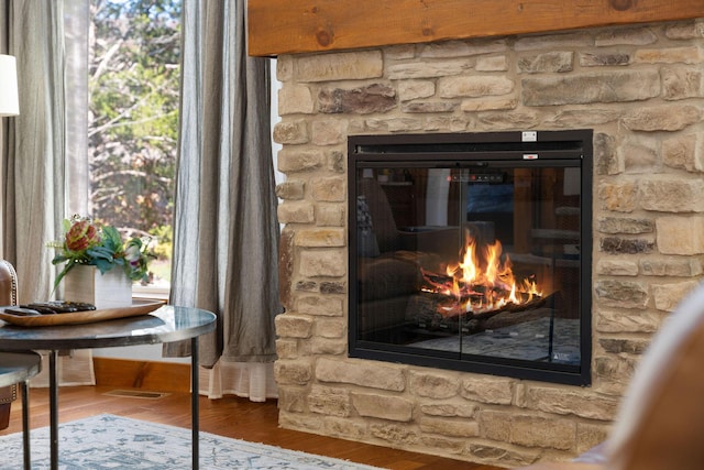 290 Deep Frst Unit 58, Hollister, MO 65672 - detailed view of a stone fireplace and wood finished floors