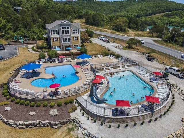 290 Deep Frst Unit 58, Hollister, MO 65672 - aerial view of property and surrounding area featuring a pool area and a heavily wooded area