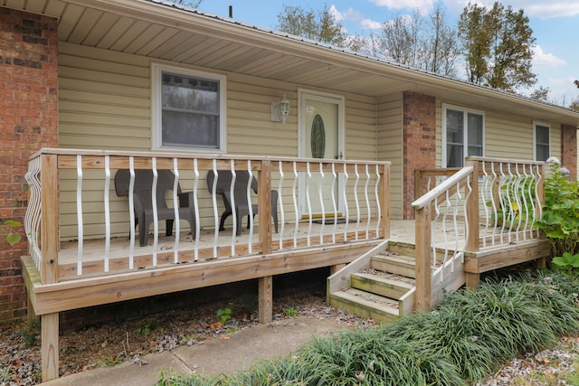 view of exterior entry featuring a wooden deck