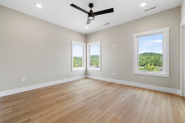 empty room featuring ceiling fan and light hardwood / wood-style floors