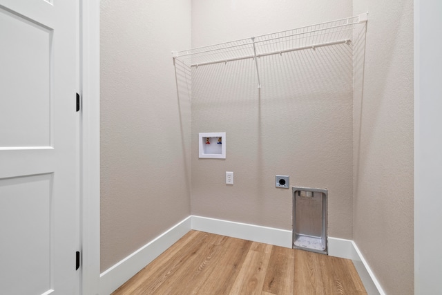 clothes washing area with hardwood / wood-style floors, electric dryer hookup, and washer hookup