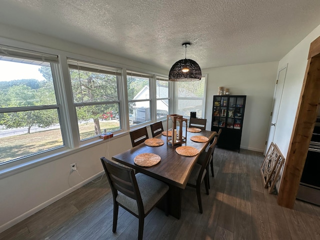 dining room with dark hardwood / wood-style flooring and a textured ceiling