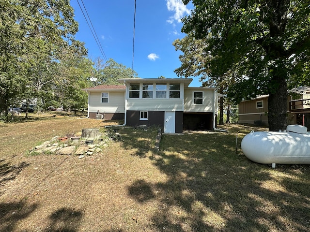 rear view of house featuring a yard