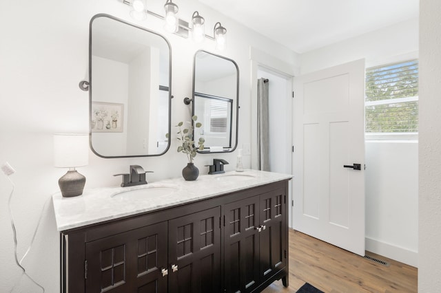 bathroom featuring vanity, hardwood / wood-style flooring, and walk in shower