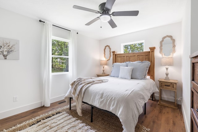 bedroom with ceiling fan and dark wood-type flooring