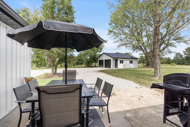 view of patio / terrace featuring a garage and an outbuilding