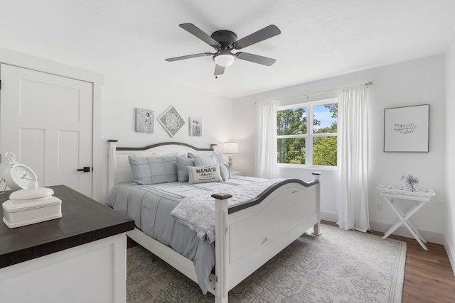 bedroom with ceiling fan and dark hardwood / wood-style floors