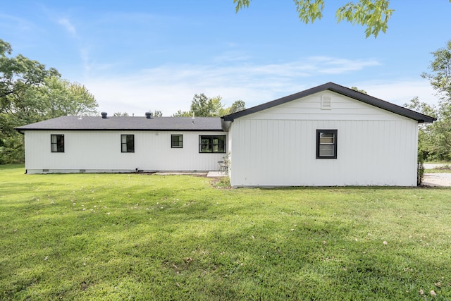 rear view of property featuring a yard