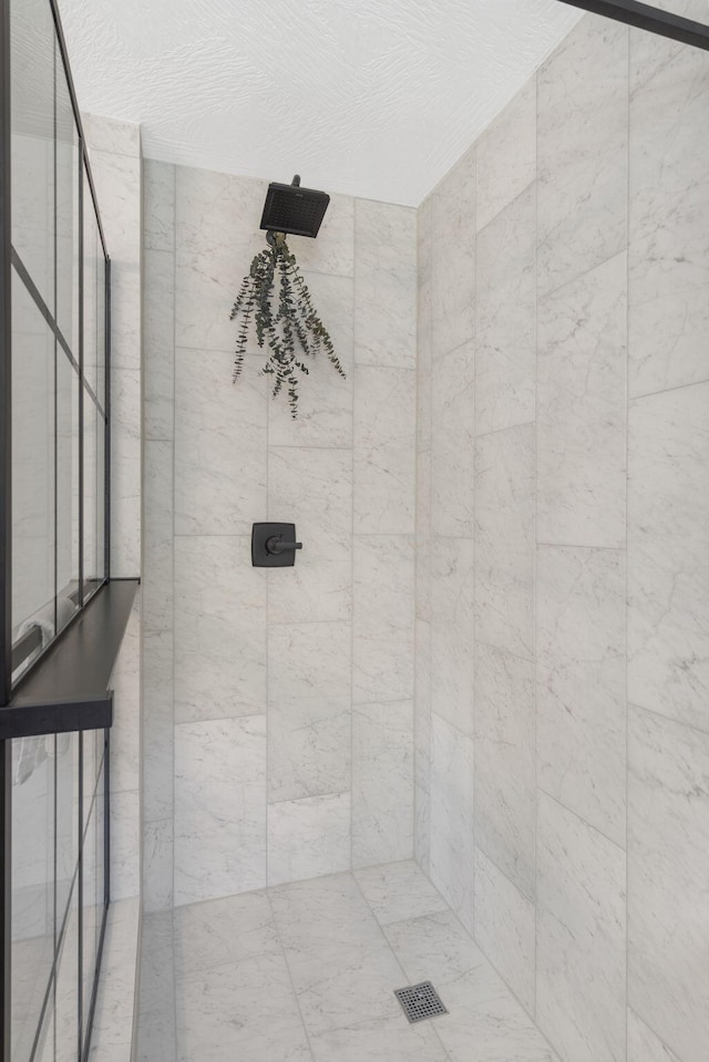 bathroom with a tile shower