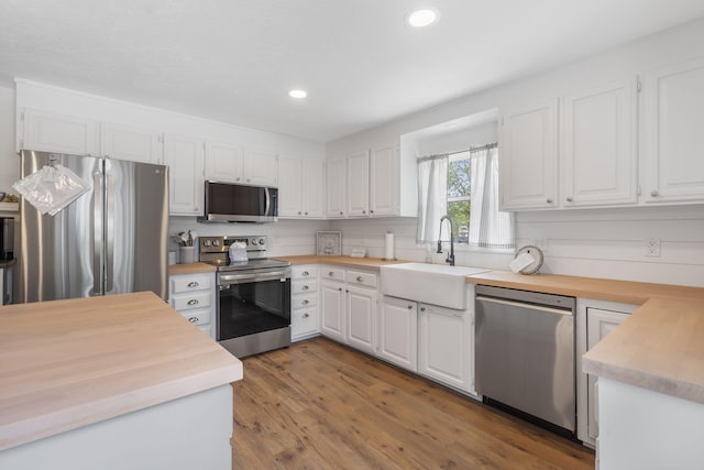 kitchen featuring white cabinets, dark hardwood / wood-style floors, sink, and stainless steel appliances