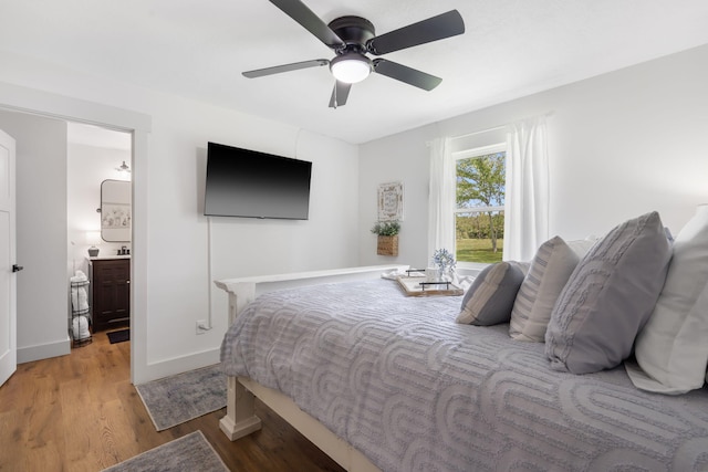 bedroom featuring ensuite bathroom, ceiling fan, and wood-type flooring