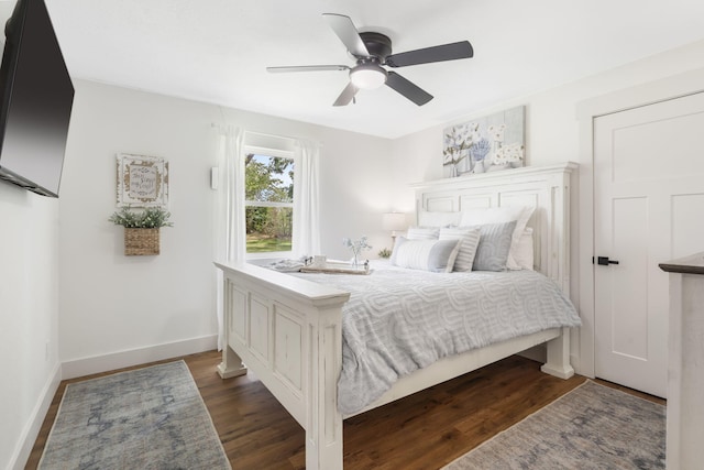 bedroom with ceiling fan and dark hardwood / wood-style flooring