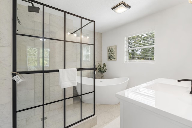 bathroom featuring a textured ceiling and separate shower and tub