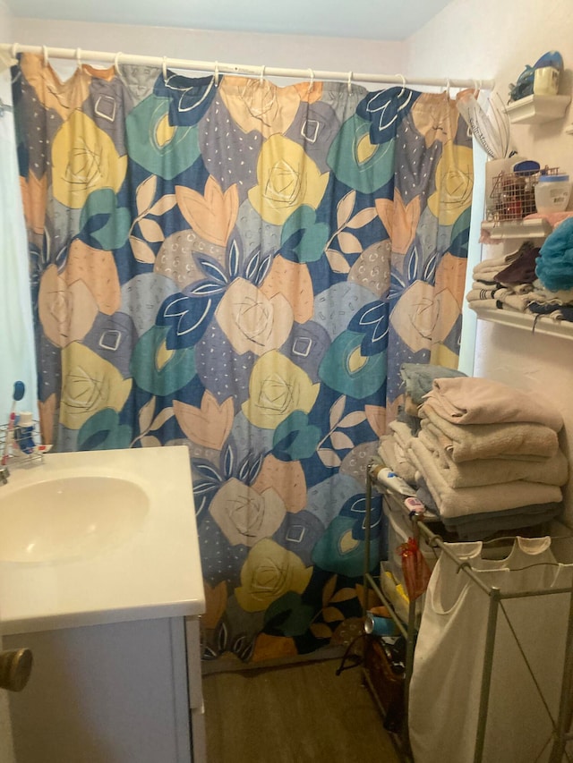 bathroom with hardwood / wood-style floors and vanity