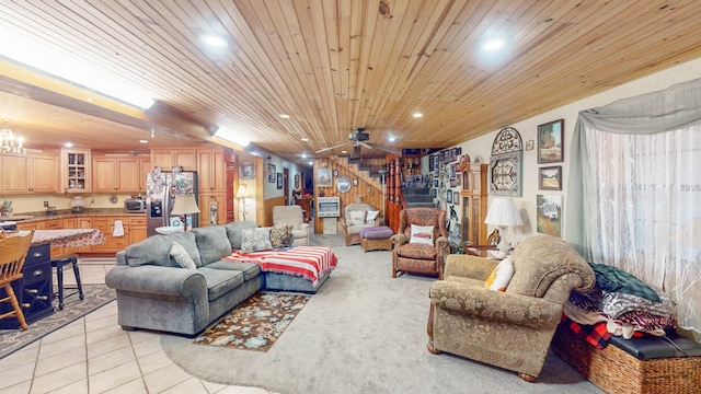 tiled living room with ceiling fan with notable chandelier and wood ceiling