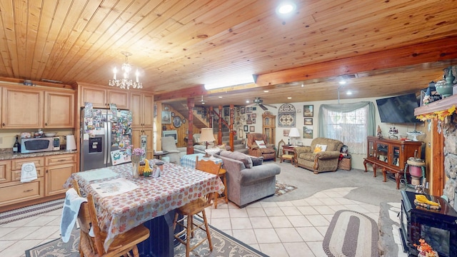 interior space featuring an inviting chandelier, light brown cabinetry, appliances with stainless steel finishes, light tile patterned flooring, and wood ceiling