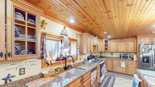 kitchen featuring stainless steel appliances, light stone counters, wood ceiling, and sink