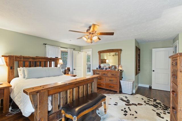 bedroom with ceiling fan and dark wood-type flooring