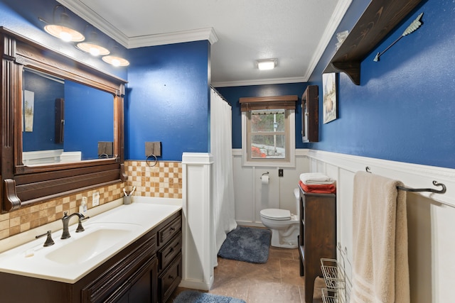 bathroom featuring tile patterned floors, vanity, toilet, and crown molding