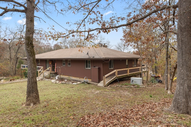 back of house with a lawn