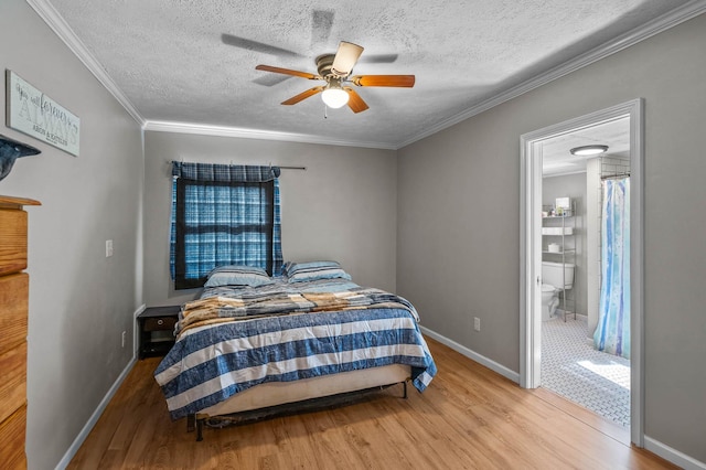 bedroom featuring a textured ceiling, light hardwood / wood-style flooring, ceiling fan, and ornamental molding