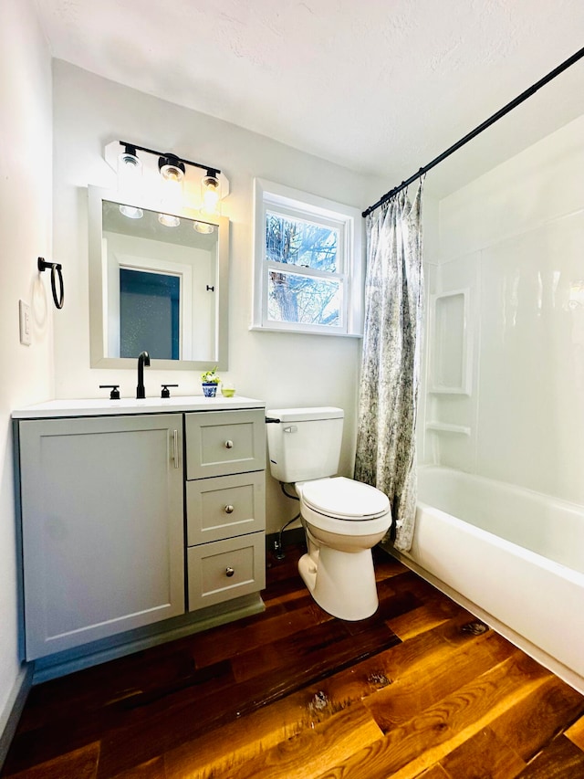 full bathroom featuring shower / bath combo, toilet, wood-type flooring, and vanity