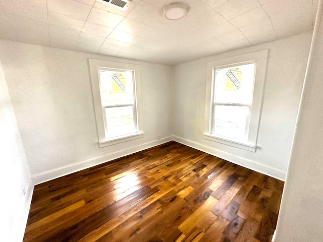 empty room with dark wood-type flooring