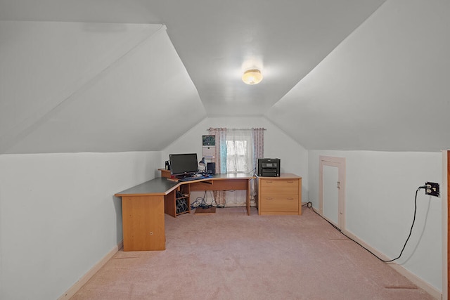 carpeted office with lofted ceiling