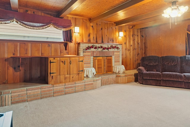 living room with beamed ceiling, carpet, wood ceiling, and wood walls