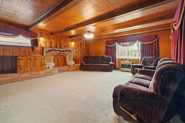 carpeted living room with beam ceiling, wooden ceiling, ceiling fan, and wooden walls