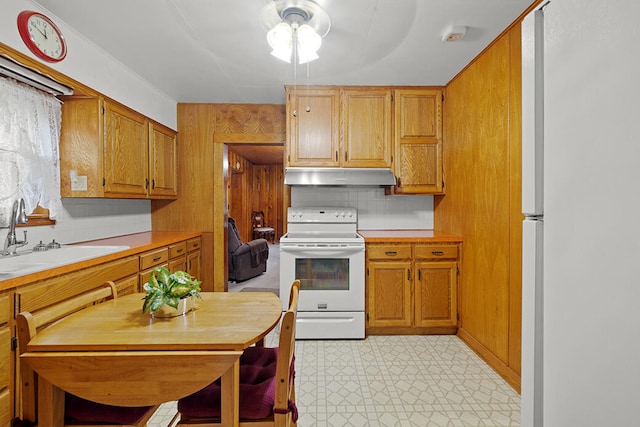 kitchen featuring ceiling fan, white appliances, sink, and tasteful backsplash