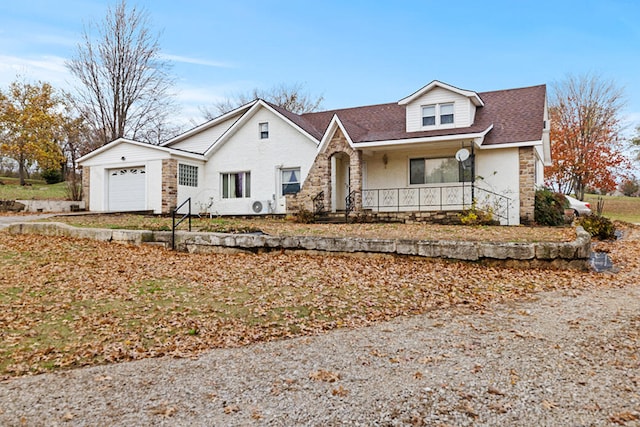 view of front of property featuring a porch and a garage