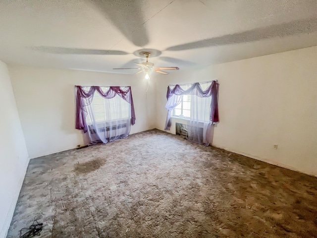 spare room featuring carpet flooring and ceiling fan