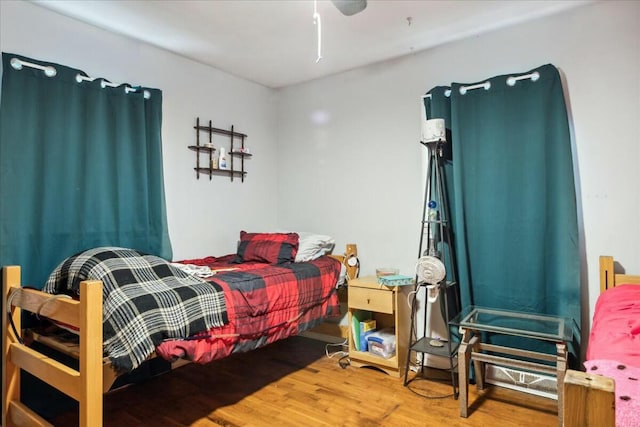 bedroom with hardwood / wood-style flooring and ceiling fan