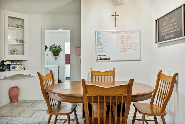 tiled dining room featuring washer / clothes dryer