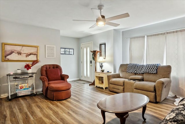 living room featuring hardwood / wood-style flooring and ceiling fan