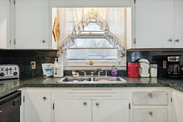 kitchen featuring white cabinets and sink