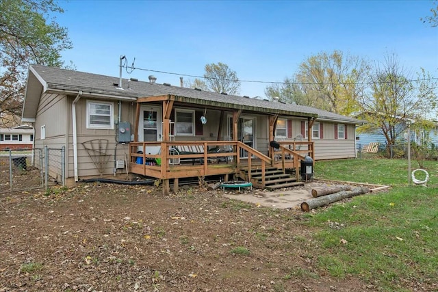 rear view of property featuring a yard