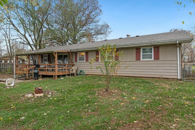 view of front of home with a front yard and a deck