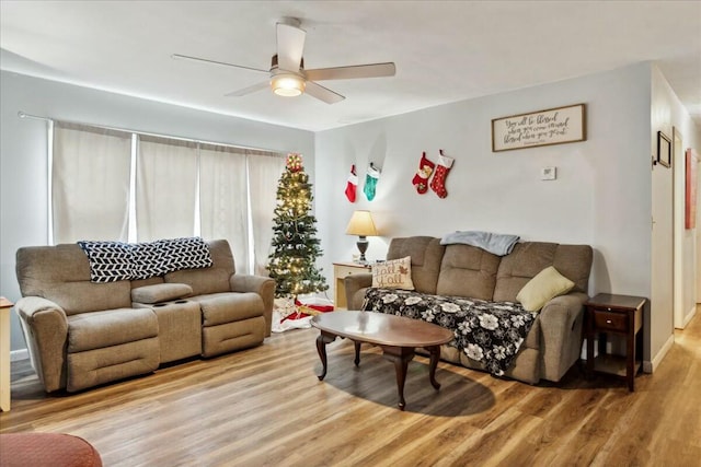 living room with light wood-type flooring and ceiling fan